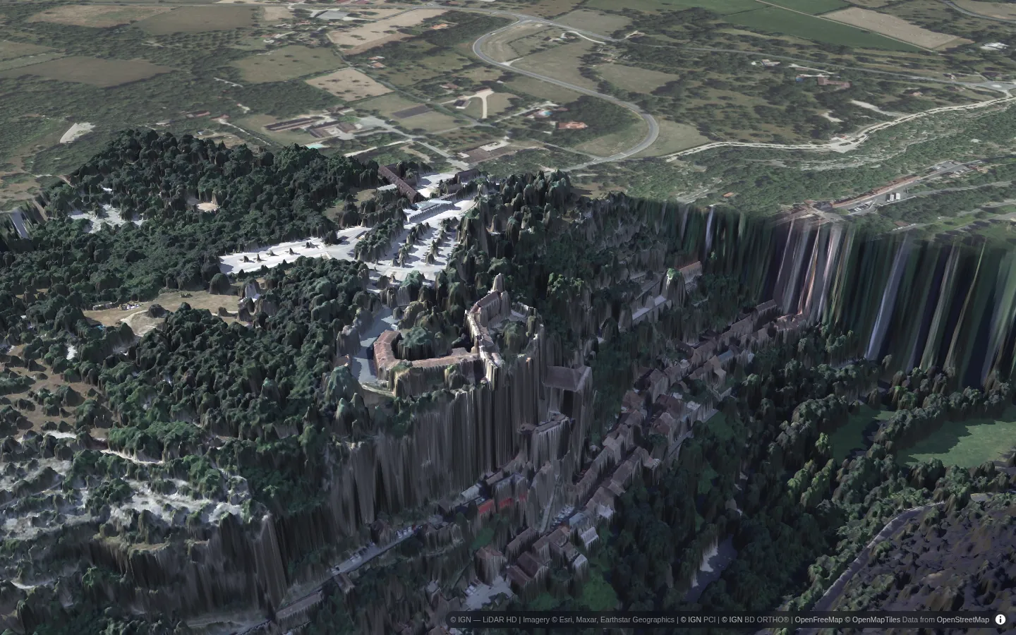 Rocamadour seen from above the cliff, the château and village lit by the evening sun